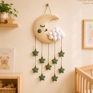 May include: A woven crescent moon wall hanging with a sleepy face, a cloud, and dangling green stars. The wall decor is handmade and includes the text "Crescent Moon Pattern".