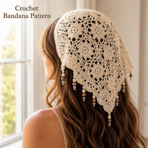May include: A beige crochet bandana featuring a repeating floral motif pattern. The triangular head covering is adorned with dangling wooden and clear glass beads along the bottom edge. The text Crochet Bandana Pattern is visible.