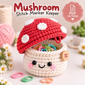 May include: A crochet mushroom stitch marker keeper with a red cap featuring white spots and a cream-colored base. The base has a smiling face with black eyes and pink cheeks, a wooden button on the side, and contains colorful plastic stitch markers.