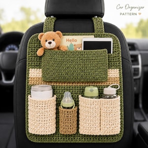 May include: A green crocheted car seat organiser featuring the text Car Organizer PATTERN. It includes a large top pocket, three bottom pockets in cream and brown, and holds a teddy bear, a tablet, a white cup, a baby bottle, and two water bottles.