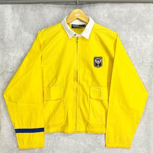 Chaqueta náutica amarilla de los años 90 de POLO Ralph Lauren, cortavientos con parche de escudo y logotipo bordado.