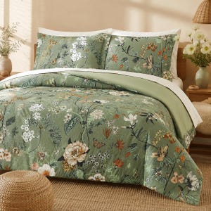 May include: A sage green duvet cover and two matching pillow shams featuring a botanical print of white, orange, and brown flowers, green leaves, and butterflies. The bedding set includes a solid white flat sheet layered underneath the duvet.