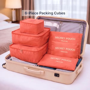 May include: A set of six coral-colored packing cubes and pouches inside an open beige suitcase. The cubes are various sizes, with zippered closures. The pouches are labeled "SECRET POUCH TRAVEL". The text "6-Piece Packing Cubes" is at the top.