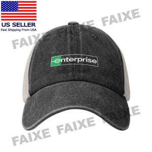 May include: A black trucker hat with a mesh back and a curved brim. The front of the hat features the word "enterprise" in white text inside a green rectangle. The hat has a distressed look.