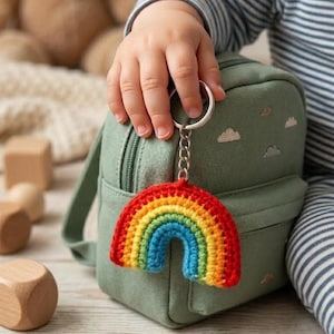 May include: A set of three ceramic mugs with a speckled, matte finish. The mugs are in shades of cream, light gray, and dark gray. Each mug has a simple, minimalist design and a rounded handle.