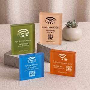 May include: Four rectangular acrylic signs in olive green, peach, blue, and orange, each featuring a Wi-Fi icon, network name, password, and QR code. The signs are labeled ERIKAGIFTCO and display unique network credentials for various settings.