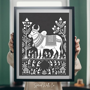 May include: Black framed art print featuring a white illustration of a bull with decorative patterns, surrounded by stylized trees and figures. The print includes the text "Storied Walls Co" at the bottom.