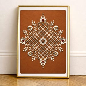 May include: A rectangular wall art print in a gold frame featuring a symmetrical white mandala pattern on a solid terracotta orange background. The intricate design includes geometric grid lines, floral motifs, and small dots in a repeating layout.