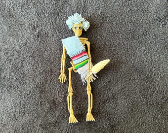Baby blue Sarape day of the dead skeleton ornament with a flower crown and elote #05