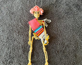 Peach Sarape day of the dead skeleton ornament with a flower crown and a beer #10