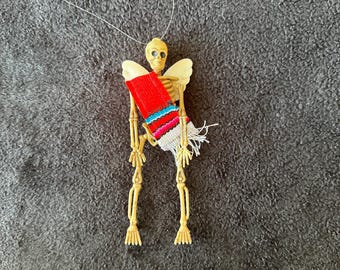 Red Sarape day of the dead skeleton ornament with wings