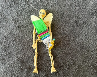 Green Sarape day of the dead skeleton ornament with wings and a soda
