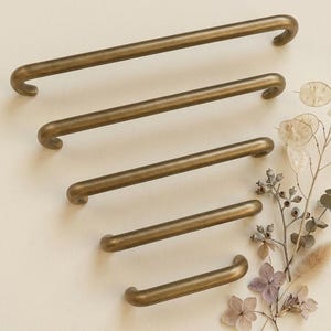 May include: A set of three ceramic mugs with a speckled, matte finish. The mugs are in shades of cream, light gray, and dark gray. Each mug has a simple, minimalist design, perfect for coffee or tea.