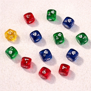 May include: An assortment of colorful polyhedral dice for tabletop games. The dice are in various colors, including red, green, blue, and yellow. Each die features different numbers and symbols, with a variety of faces. The dice are arranged on a white surface.