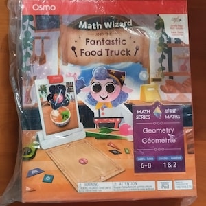 May include: A boxed Osmo Math Wizard and the Fantastic Food Truck educational game. The box features a cartoon character and the text "Math Wizard and the Fantastic Food Truck". The game is designed for ages 6-8 and grades 1 & 2.