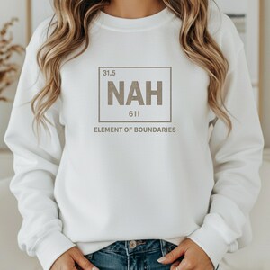 May include: White sweatshirt with a graphic design. The design features the word "NAH" in a box, with the numbers "31,5" and "611" above and below it, and the text "ELEMENT OF BOUNDARIES" below the box.