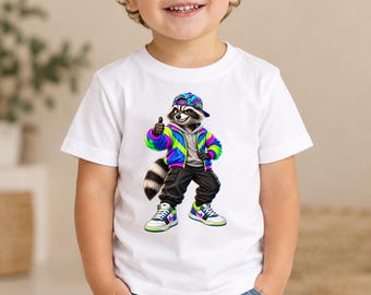 May include: A white short-sleeved t-shirt featuring a graphic print of a raccoon wearing a colorful neon jacket, black cargo pants, a patterned baseball cap, and high-top sneakers. The raccoon is giving a thumbs-up gesture.