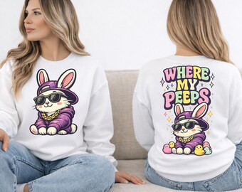 May include: White sweatshirt featuring a cartoon rabbit wearing sunglasses, a purple hoodie, and a gold chain. The front of the sweatshirt shows the rabbit, while the back displays the text "WHERE MY PEEPS" in colorful letters, with a similar rabbit design below.