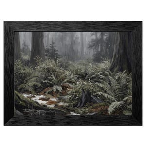 May include: A framed landscape painting of a misty forest scene. The artwork features tall trees, ferns, and a stream, all rendered in muted greens, browns, and grays. The painting is enclosed in a black wooden frame.