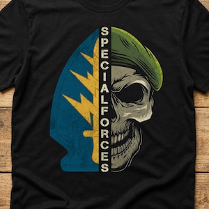 May include: A black short-sleeved t-shirt featuring a graphic print. The design is split vertically, showing a blue and yellow lightning bolt and dagger emblem on the left and a skull wearing a green beret on the right, with the text SPECIAL FORCES.