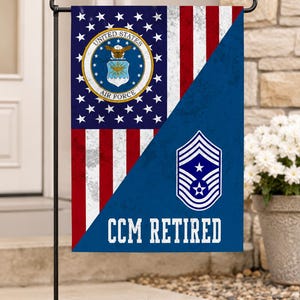 May include: A rectangular garden flag featuring a diagonal split design. The top left displays the United States Air Force emblem on a blue field with white stars and red and white stripes. The bottom right is blue with a Chief Master Sergeant rank insignia and the white text CCM RETIRED.
