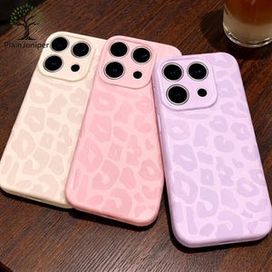 May include: A white ceramic mug with a black handle and the text "But First, Coffee" in a bold, black font. The mug is set against a blurred background, highlighting its simple design.