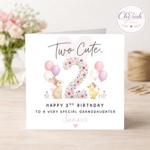 May include: A square birthday greeting card featuring the text Two Cute and Happy 2nd Birthday to a very special granddaughter Summer. The design includes a large floral number two, a brown bunny, a yellow duckling, and pastel balloons.