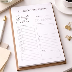 May include: A white ceramic mug with a black handle and the text "But First, Coffee" in a handwritten style. The mug is on a white surface. The mug is approximately 4 inches tall.