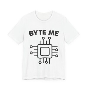 May include: White t-shirt with the phrase "BYTE ME" in black, distressed font above a black and white circuit board graphic. The shirt has a crew neck and short sleeves. A casual, tech-themed apparel item.