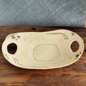 May include: A rustic wooden sign with the text "Welcome to our home" in white lettering. The sign has a distressed finish and a simple, inviting design, ideal for front door decor.