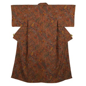 May include: A brown kimono with a detailed floral pattern in shades of red, yellow, and blue. The traditional Japanese garment features wide sleeves and a full length design. The kimono is displayed against a white background.