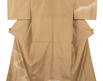 May include: A tan kimono with a subtle textured pattern. White cloud-like designs with dotted accents adorn the sleeves and hem. Gold-colored accents are visible near the sleeves. The garment is displayed open, showcasing its full form.