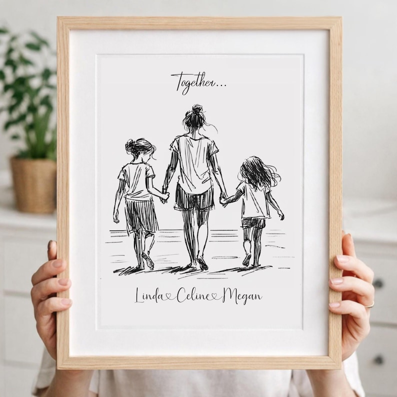 May include: A framed black and white sketch print. The artwork depicts a mother and two children walking hand-in-hand. The text "Together..." is above the figures, and the names "Linda, Celine, Megan" are below.
