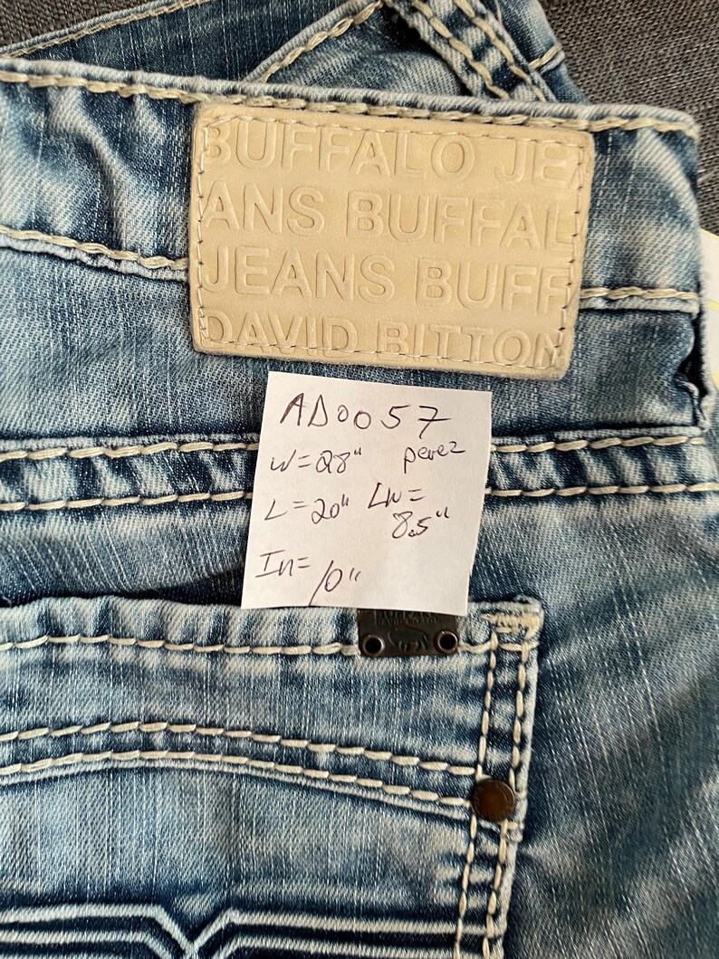 May include: A set of three ceramic mugs with a speckled, matte finish. The mugs are in shades of cream, light gray, and dark gray. Each mug has a simple, minimalist design, perfect for coffee or tea.