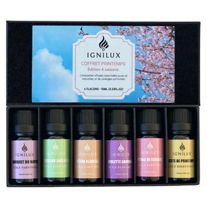 Peut inclure: Un coffret noir contenant six petits flacons d'huiles essentielles. Chaque flacon a une étiquette de couleur différente et un bouchon noir. Le couvercle de la boîte porte le texte "IGNILUX COFFRET PRINTEMPS Édition 4 saisons". Chaque flacon contient 10 ml d'huile essentielle.