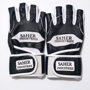 May include: A pair of black and white fingerless gloves featuring a textured leather construction with white mesh panels. The text SAHER INDUSTRIES is printed in black on the white mesh and on the white rectangular hook-and-loop wrist straps.