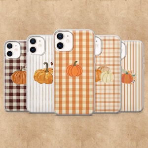 May include: Five phone cases with autumnal designs. The cases display pumpkins, plaid, and striped patterns in orange, brown, and white. Each case has a unique design, ideal for the autumn season.