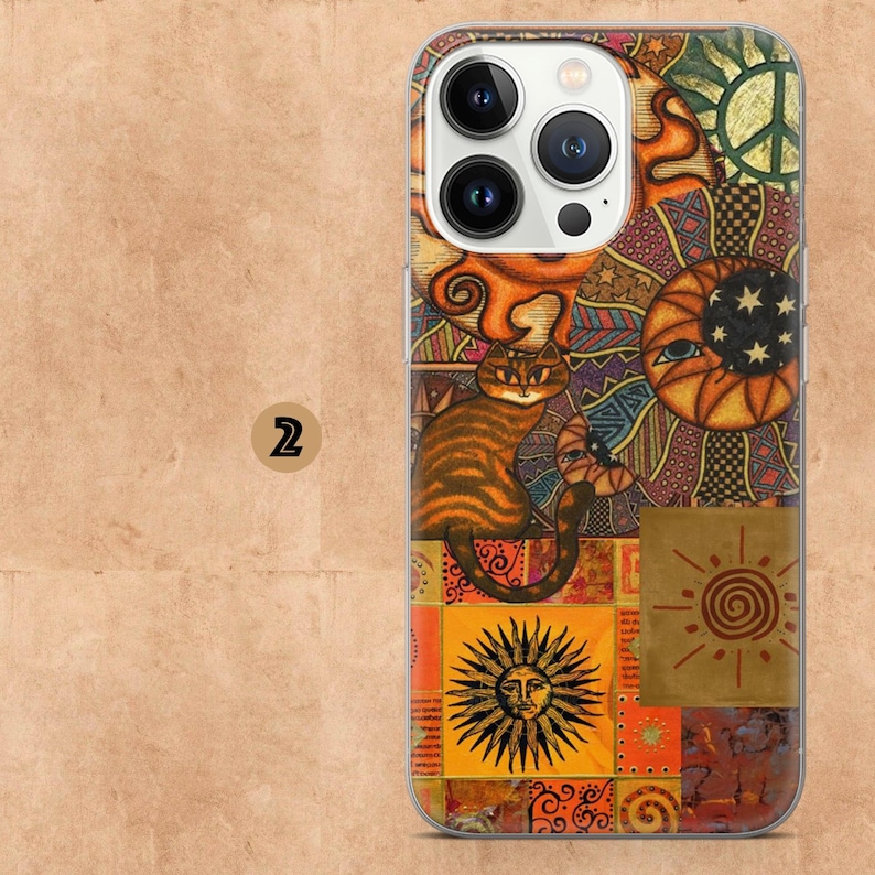 May include: A colorful phone case featuring a patchwork design with a cat, sun, moon, and peace sign. The case has a clear border and a vibrant, artistic aesthetic. The cat is orange and brown, and the sun has a face.