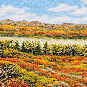 May include: A detailed landscape painting depicting a vibrant autumn scene. The artwork showcases a river, colourful foliage in shades of orange, yellow, and red, and a blue sky with fluffy white clouds. The foreground features textured trees.