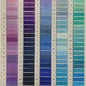 May include: A color chart featuring five vertical columns labeled 16 through 20, containing rows of thread samples in shades of purple, violet, navy, blue, and teal. Each sample is paired with a unique alphanumeric code printed in black text.
