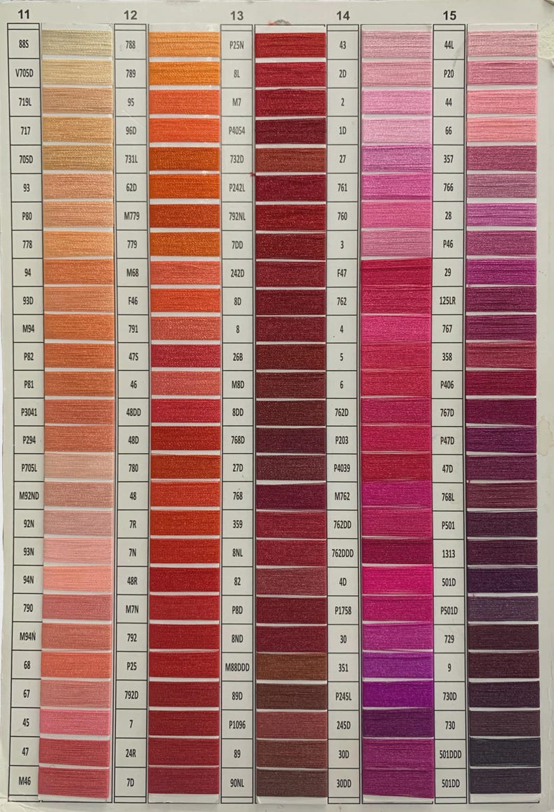 May include: A color chart displaying a wide range of thread colors, from light beige to deep burgundy and purple. Each color is labeled with a number and code, ideal for craft projects.