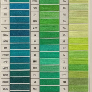 May include: Color chart of embroidery floss in shades of green, teal, and yellow. Each color is labeled with a number and a letter combination. The chart is organized in vertical columns.