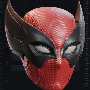 May include: A red and black mask with a textured surface, featuring pointed ear-like extensions. The mask has white eye openings and is labeled "TEST PRINTED AMS COLORED STL" and "PATREON.COM/YOSHSTUDIOS".