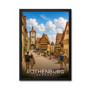 May include: A framed travel poster featuring a cobblestone street in Rothenburg, Germany, with historic half-timbered buildings, a clock tower, and people walking under a bright blue sky with white clouds. The text ROTHENBURG GERMANY is at the bottom.