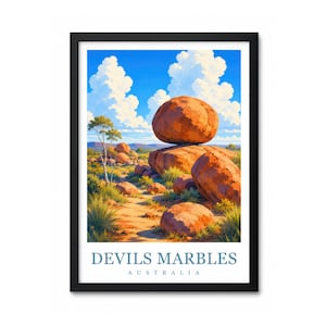May include: A framed art print featuring a landscape of large, rounded orange boulders at Devils Marbles, Australia. The scene includes a bright blue sky with white clouds, sparse green vegetation, and the text Devils Marbles Australia.