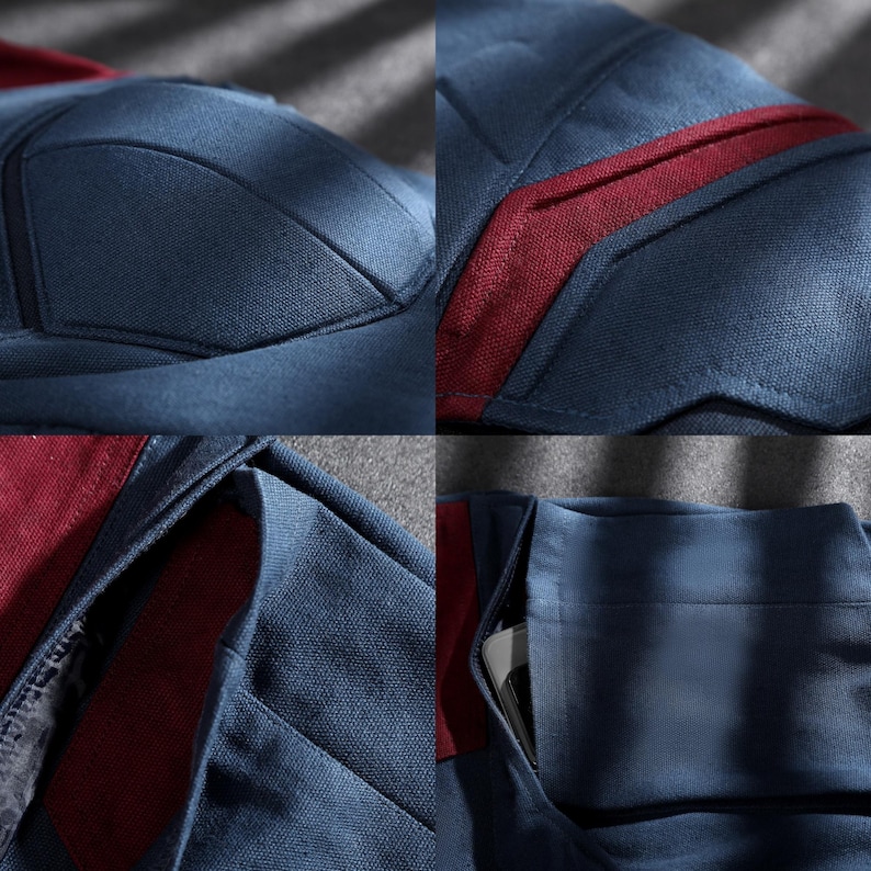 May include: Close-up of a navy blue garment with burgundy detailing. The fabric has a textured finish, with visible stitching and paneling. Features include a pocket and reinforced seams, indicating a tailored design.