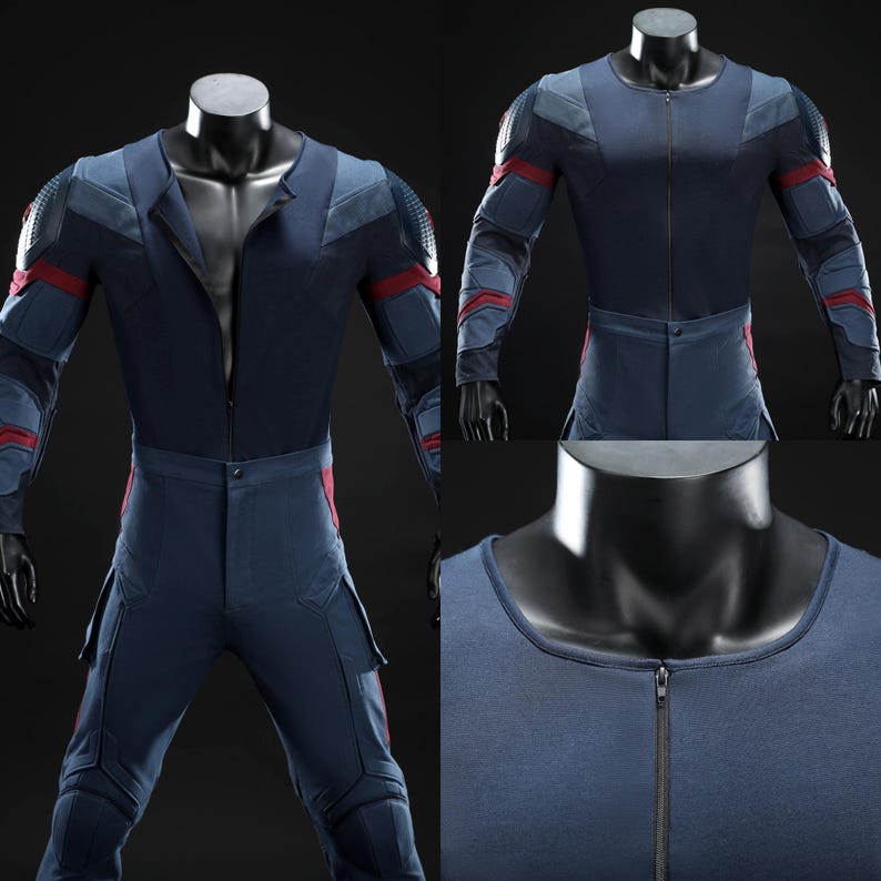 May include: A navy blue jumpsuit with red and grey detailing, presented on a mannequin. The suit has a zip-up front, padded shoulders, and red stripes on the arms and legs. The trousers include cargo pockets. The design suggests a futuristic or superhero aesthetic.