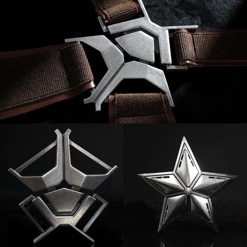 May include: Close-up of metal buckles and a star-shaped emblem. The silver buckles are attached to brown fabric straps. The star emblem is also silver and has a detailed, multi-faceted design. These appear to be costume or prop pieces.