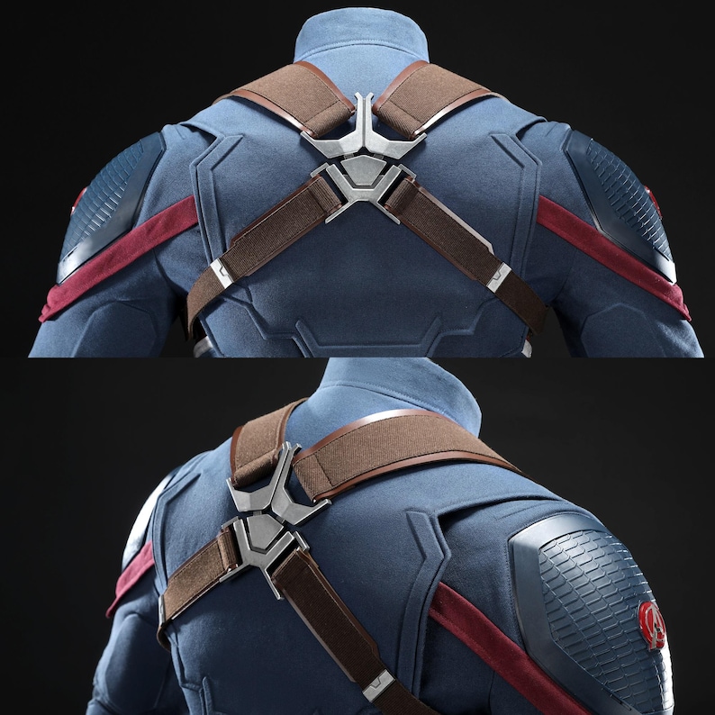 May include: Detailed view of a blue costume featuring brown straps and silver metalwork. The costume has red detailing and textured shoulder pads. The design is reminiscent of a superhero outfit.