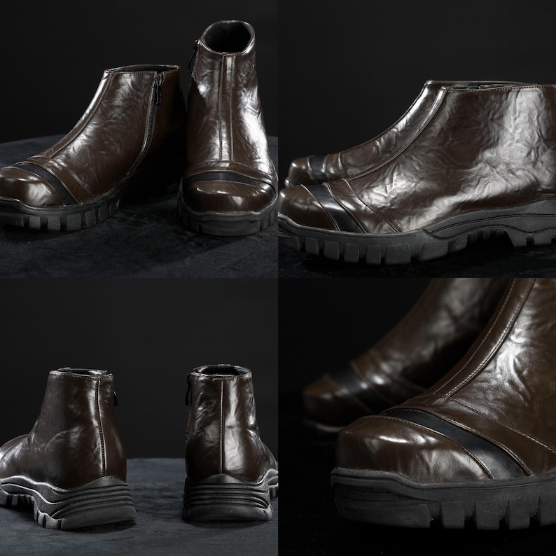 May include: Brown leather ankle boots with a zip fastening and a black rubber sole. The boots have a textured finish and a black stripe detail across the top. The boots are displayed on a dark surface.